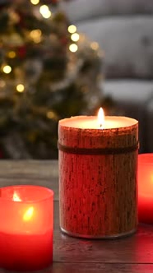 Burning Christmas Candles with Christmas Tree in Background