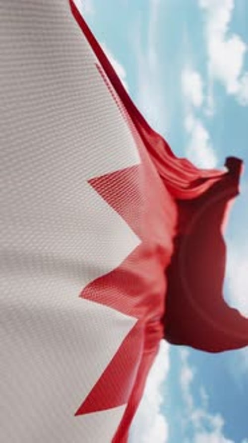 Bahrain Flag Waving In Wind Against Blue Sky Vertical Video