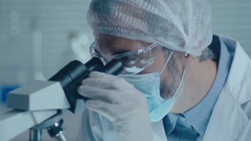 Scientist Uses Microscope in Clinical Laboratory