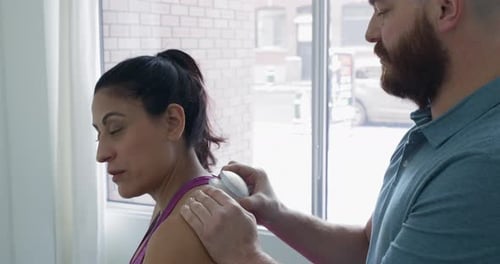 Woman Receives Cupping Therapy from Bearded Man Indoors