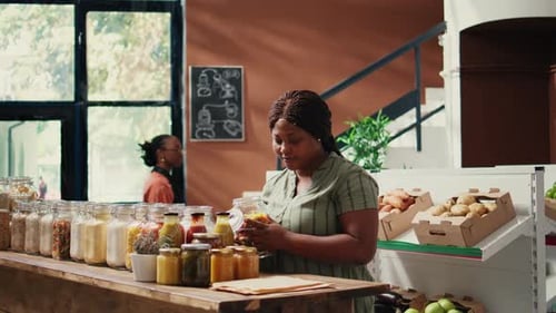 Woman Fills Paper Bag with Pasta in Store