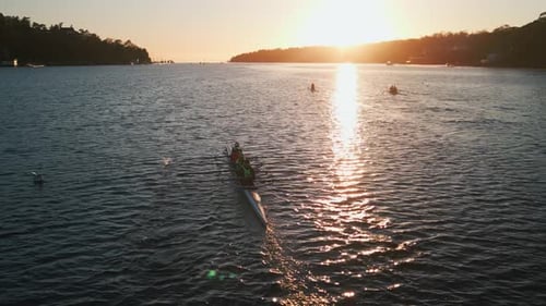 Aerial View of Rowers on Fouroar Rowing Boats on a Calm Ocean at Sunrise