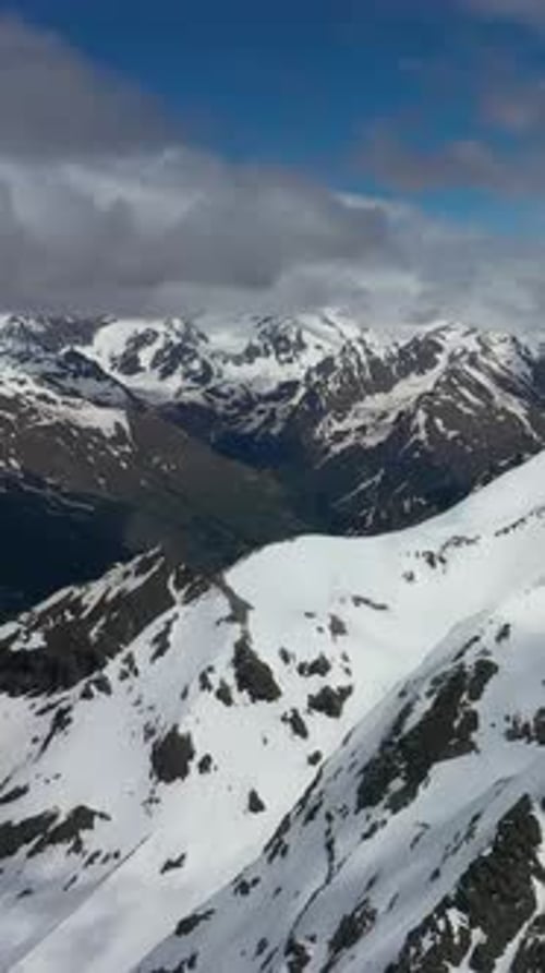 Panoramic Winter Wonderland: Alpine Mountains Covered in Snow and Ice