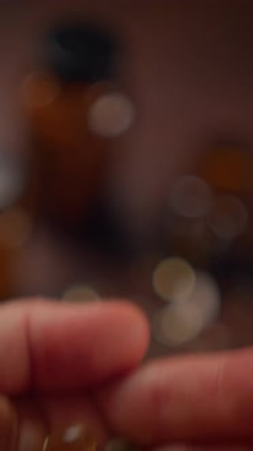 Handful of Supplements and Medicine Bottle Close Up