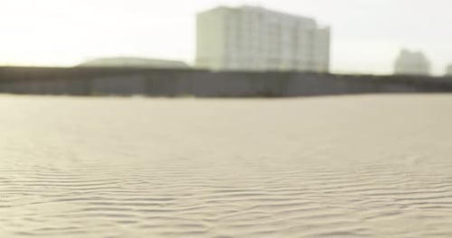 Warm Golden Sand Stretches Out Beneath Buildings Overlooking the Beach