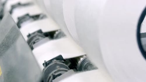 Close Up of Material Rolls on Machine in Factory