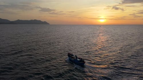 Morning lifestyle of fishermen at sea, boat sailing under sunrise