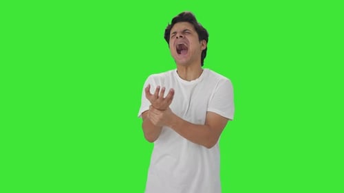 Sick Indian man having hand pain Green screen