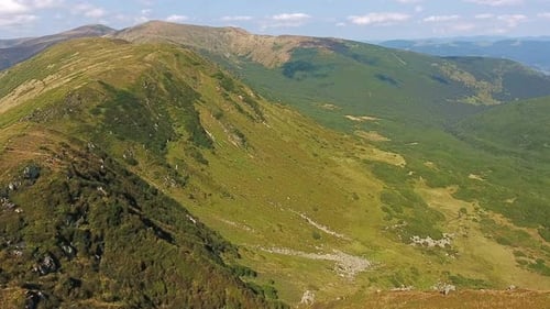Aerial View of Mountain Ridge Flight Over Summit in Sunny Summer Day