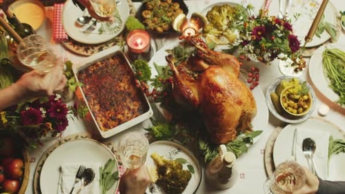 People Toasting at Festive Holiday Dinner Table
