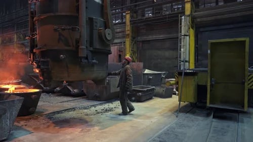 Industrial Workers Perform Tasks in Foundry Operations Covering Craftsmanship and Metal Casting