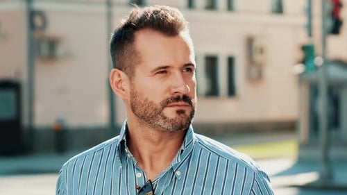 Man with Beard Standing on Urban Street