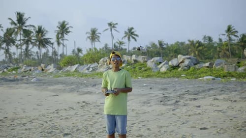 Boys flying a drone in beach side