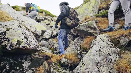 Group Hiking Across Rocky Mountain Landscape