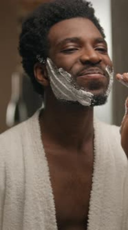 Young Adult Man Applying Shaving Cream to Face
