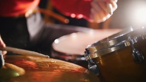 Drummer Playing Cymbals and Drums in Studio Lighting