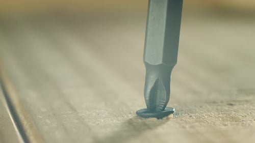 Closeup Black Self Tapping Screw Backing Out From Wooden Plank By Man Macro View Construction