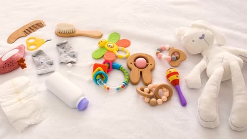 Baby Toys and Accessories on the Bed Selective Focus