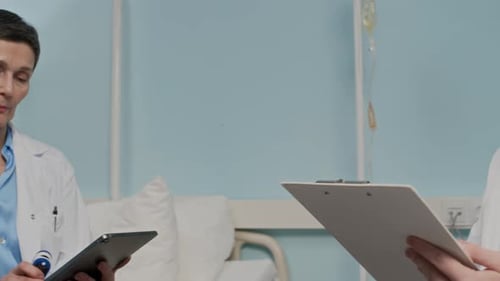 Aged Man Getting Oxygen Level Examined with Pulse Oximeter in Ward with Doctors