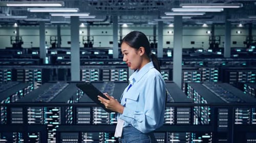 Side View Of Asian Business Woman Using Tablet In Data Center