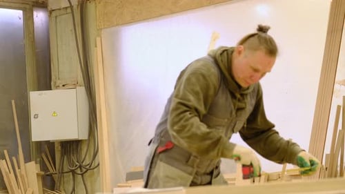 Carpenter at Workshop Polishes Wooden Board with a Electric Orbital Sander Woodwork and Furniture