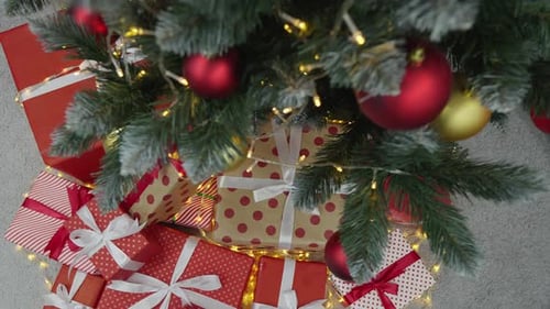 Presents Beneath Christmas Tree with Decorative Lights