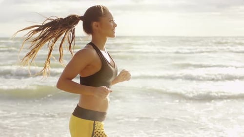 Girl is Running at Morning Time in Beach. Side Shot. Slow Motion.