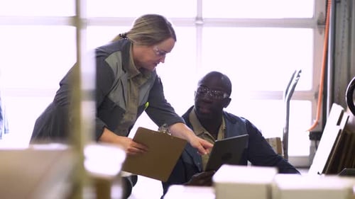Workers With Clipboard And Digital Tablet Talking In Manufacturing Plant Slow Motion