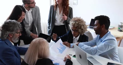 Multiracial business team collaborating on startup strategy inside bank office