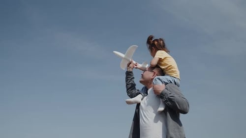 Father and Child Enjoying Airplane Watching Together