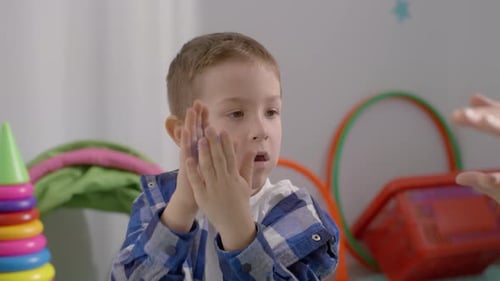 Child Playing with Spiky Ball with Adult