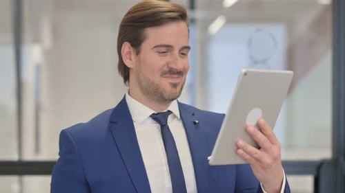 Businessman Using Tablet and Celebrating Success