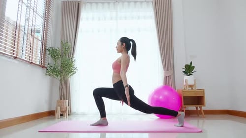Woman Stretching on Exercise Mat Indoors