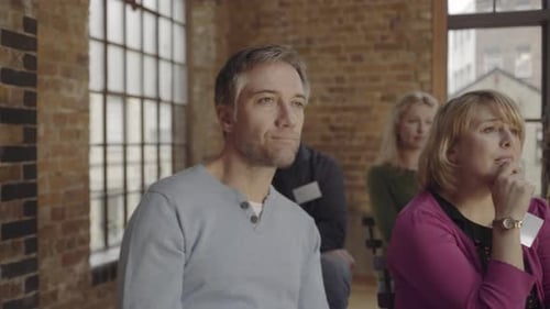 People Listening Intently in a Meeting Room