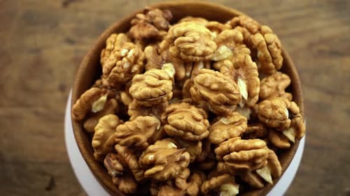 Shelled Walnuts in Wooden Bowl Rotating