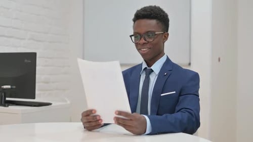 Young Adult Celebrating Corporate Success in an Office