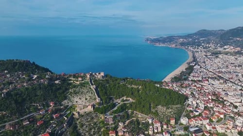 Aerial Video of a Vibrant Coastal City With a Stunning Azure Sea and a Bright Blue Sky Captured From