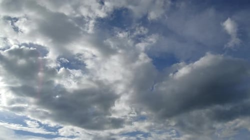 White Clouds Drifting Across Blue Sky