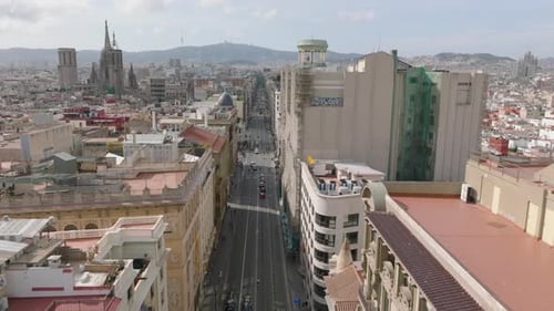 Forwards Fly Above Street in City Centre Road Lined By Multistorey Historic Buildings Barcelona