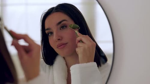 Young Woman Using Jade Roller at Home