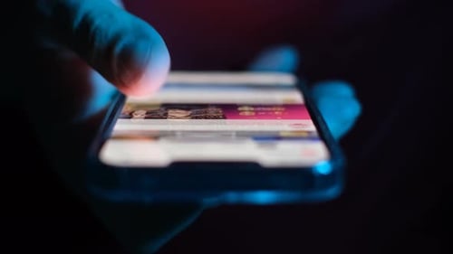Scrolling Social Media at Night on a Smartphone