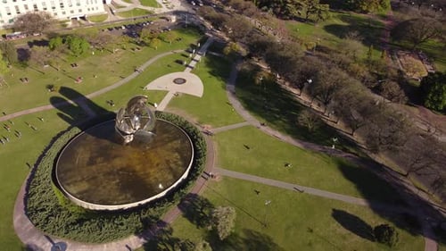 Floralis Generica steel sculpture in Buenos Aires park on sunny day, Argentina. Aerial top-down circ