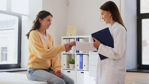 Woman Meeting Doctor in Clinic for Checkup