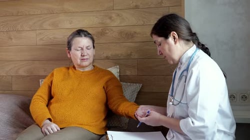 Doctor Checking Patient's Pulse at Home Visit