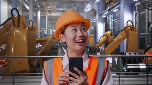 Close Up Of Asian Female Engineer Using Smartphone With Robotic Arms