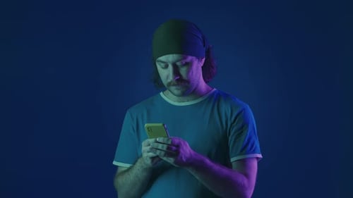 Young Adult Using Smartphone Gives Thumbs Up