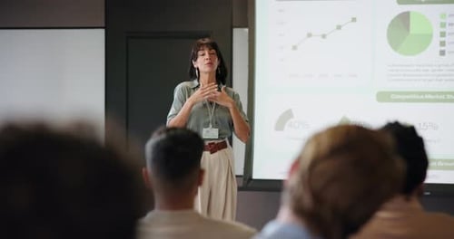 Woman Gives Presentation to Diverse Corporate Audience