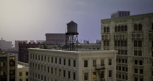 Urban Skyline at Dusk Featuring Historic Architecture and a Water Tower