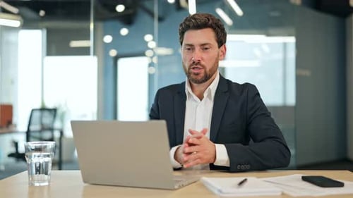 Man Video Conferencing From Office During The Day