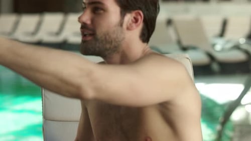 Portrait of Sexy Man Call Video Online on Mobile Phone at Hotel